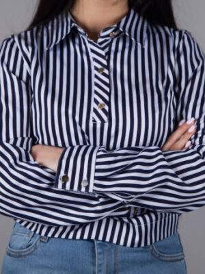 Business woman in a beautiful shirt. gray background.